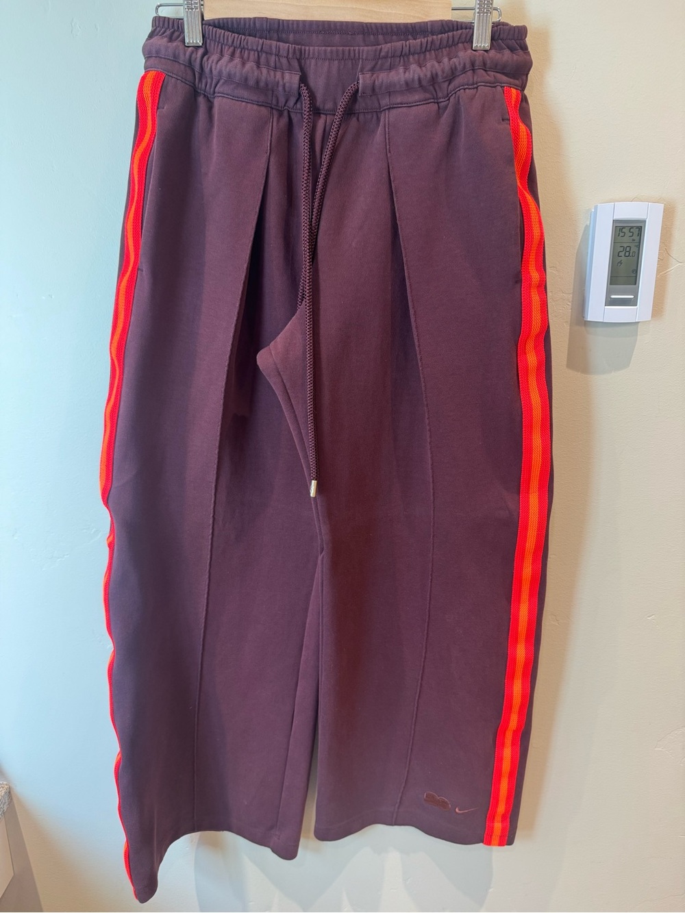 Naomi Osaka Nike Wide Leg Track Pants in Burgundy with Red & Orange Stripe.